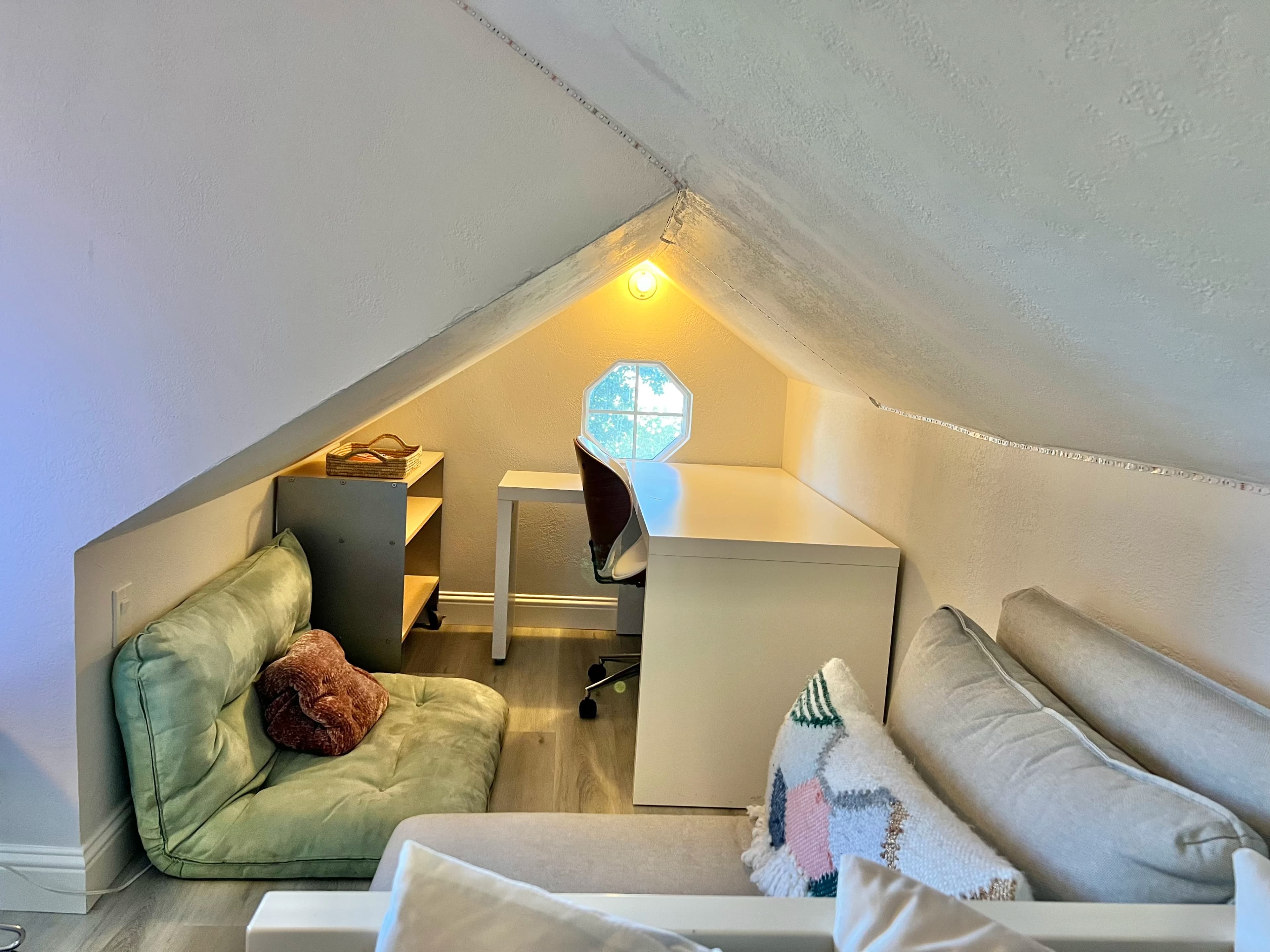 Sunny attic nook with desk and seating